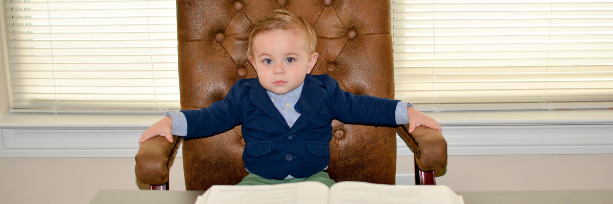 Bambino  seduto su una poltrona presidenziale